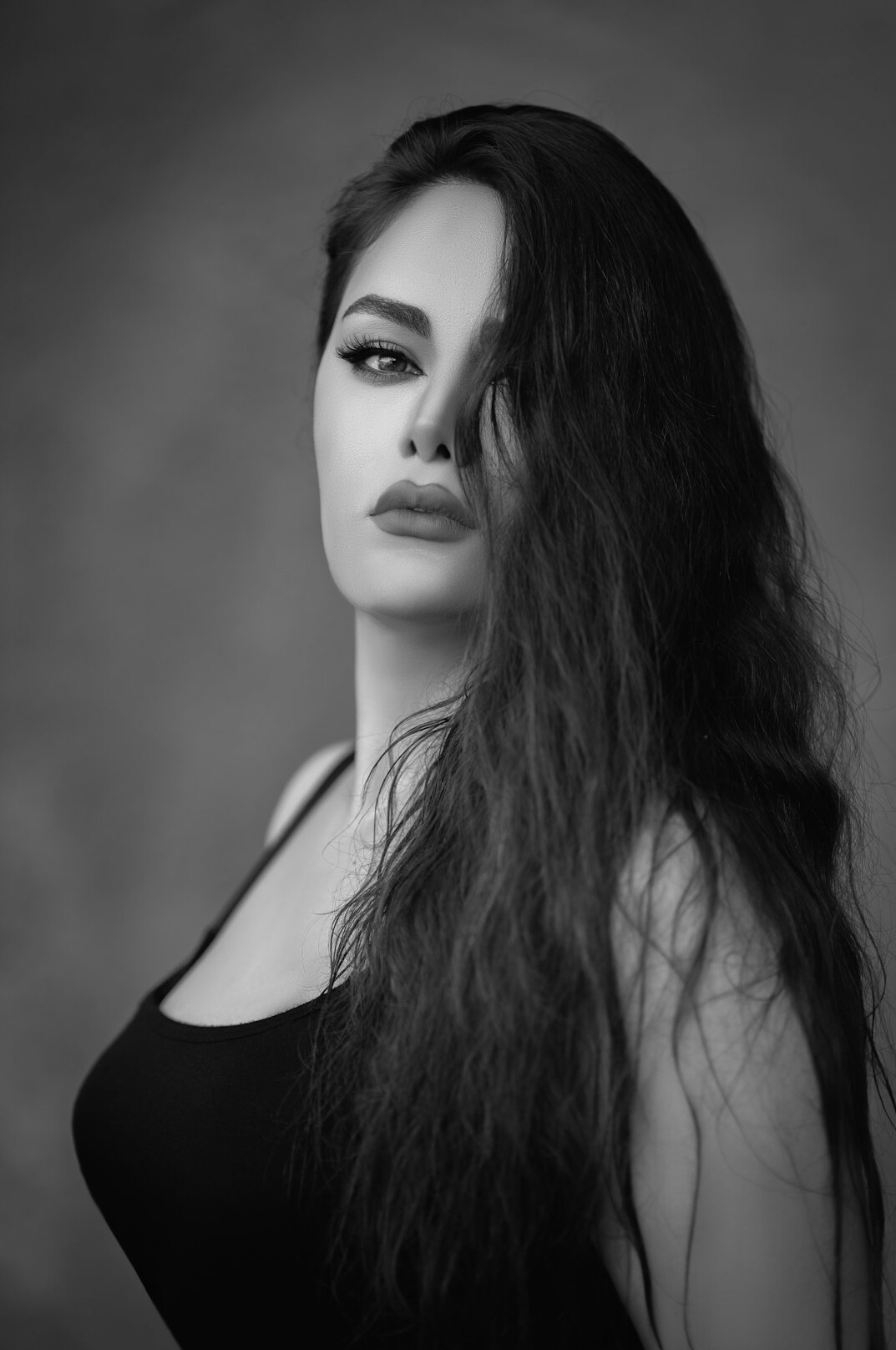 Studio portrait of a woman with long dark hair