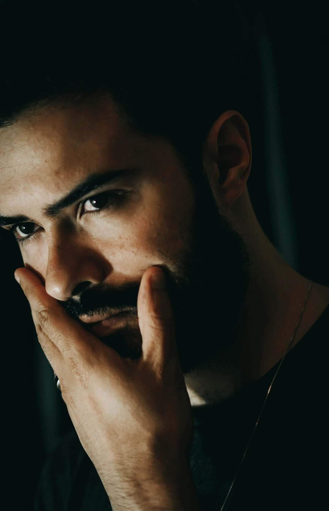 Studio portrait of a young Latino man with beard