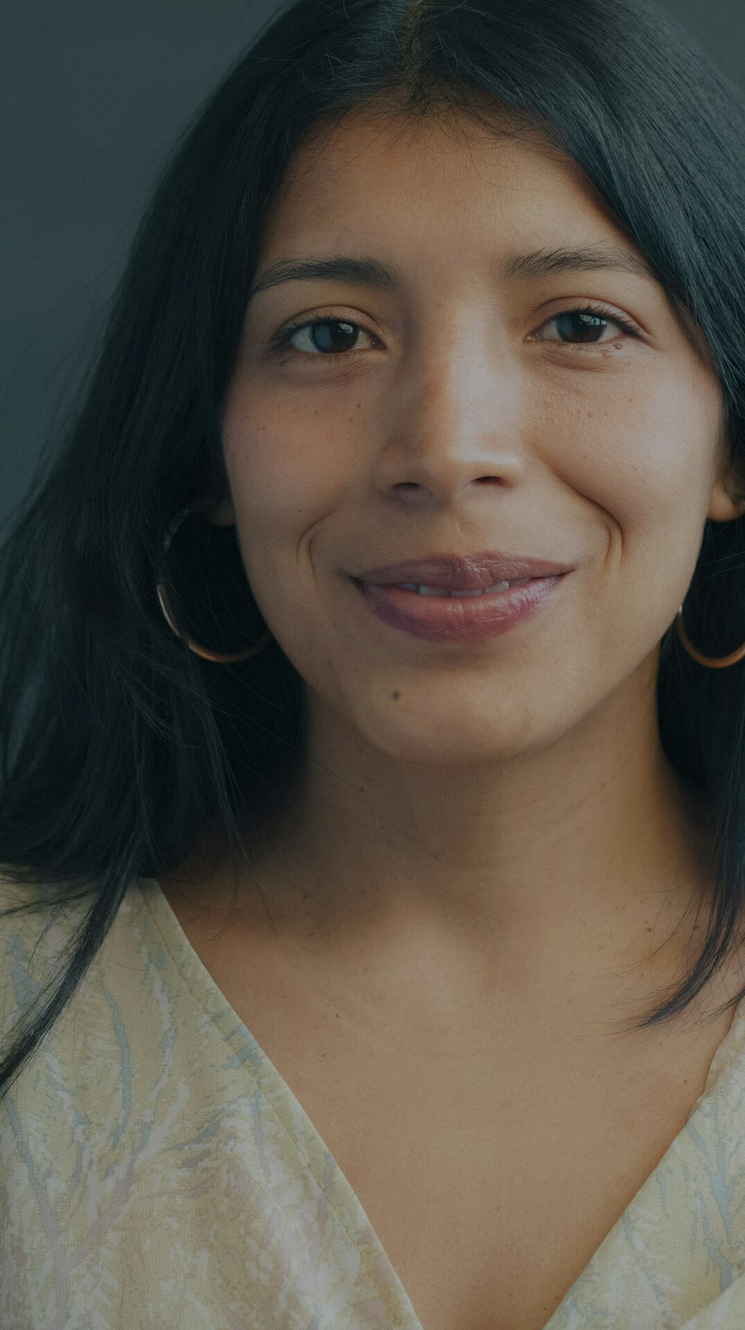 Studio portrait of a young Latina woman smiling